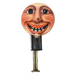 Early to mid 20th Century mechanical hand held toy with push-activated sparking eyes and mouth, overall L12cm