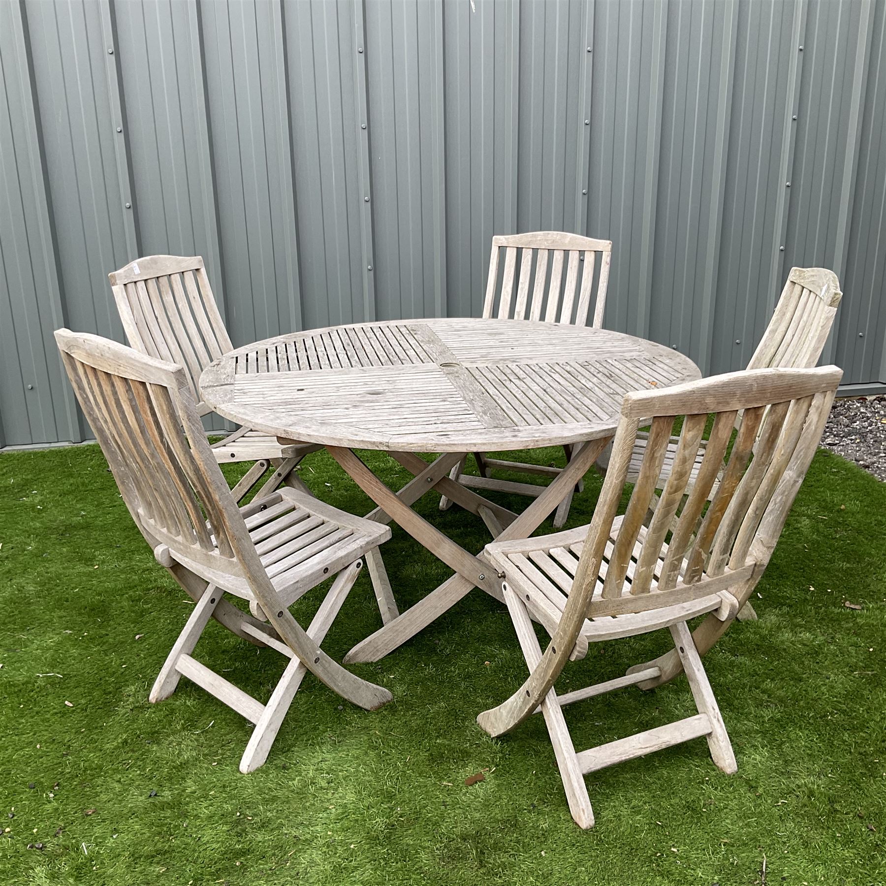 Teak circular garden folding table and five folding chairs THIS LOT