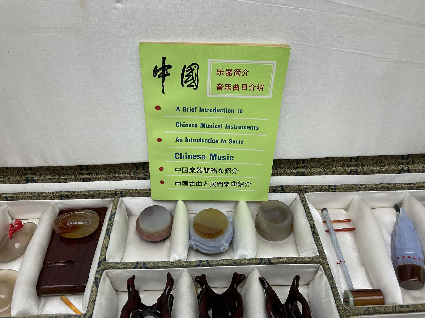 Chinese boxed collection of miniature polished hardstone musical instruments with hardwood stands