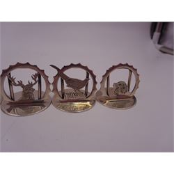 Set of six modern silver place card holders, each of circular form with pierced depictions of a partridge, spaniel, pheasant, stag, woodcock and duck, hallmarked J A Campbell, London 1985, contained within a velvet and silk lined fitted case, H3cm