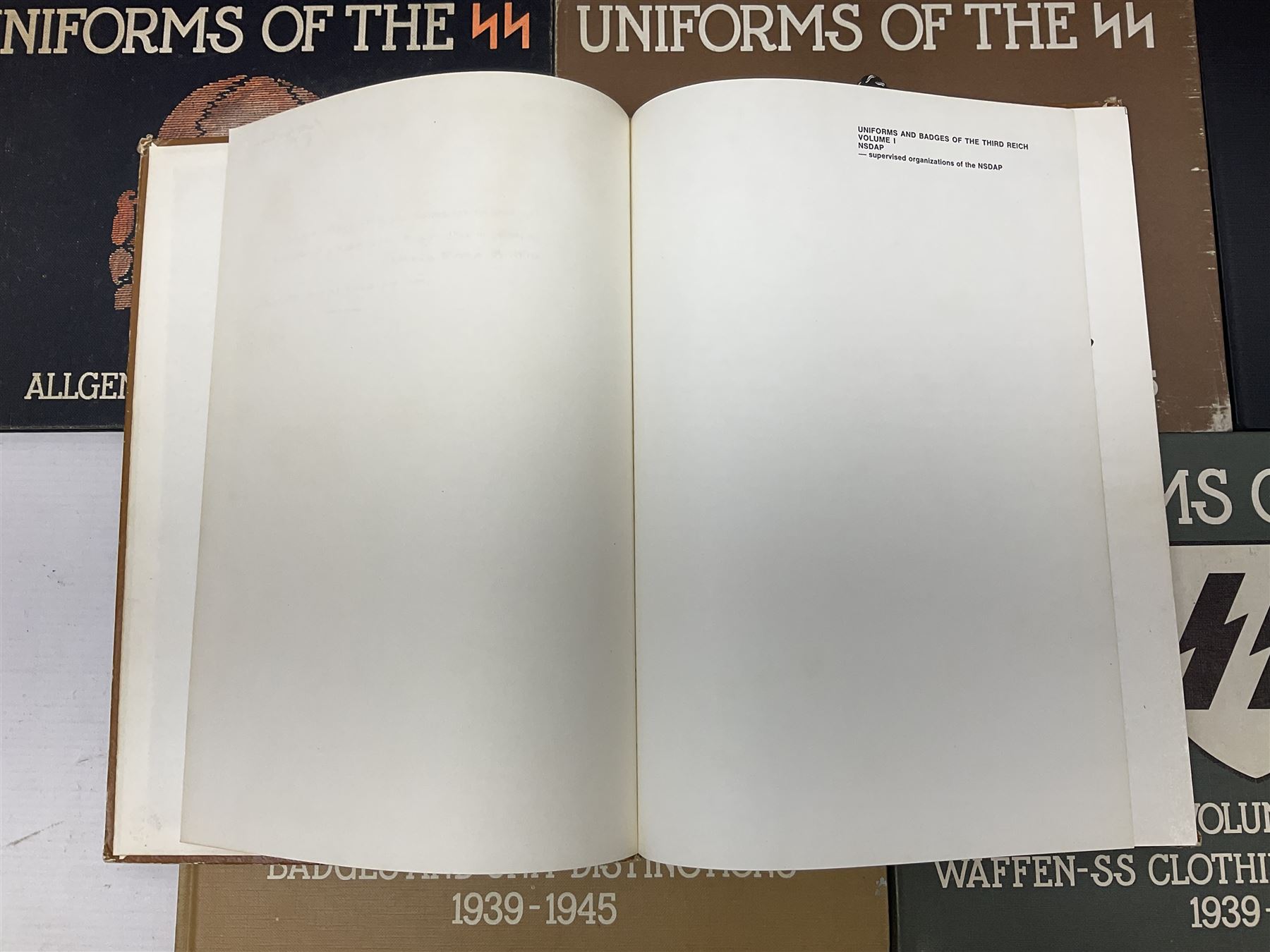 Military Collectors Service: set of three books on WWII German uniforms and badges; and Mollo Andrew: Uniforms of the SS. Volumes 1,4,5,6 & 7 (8)