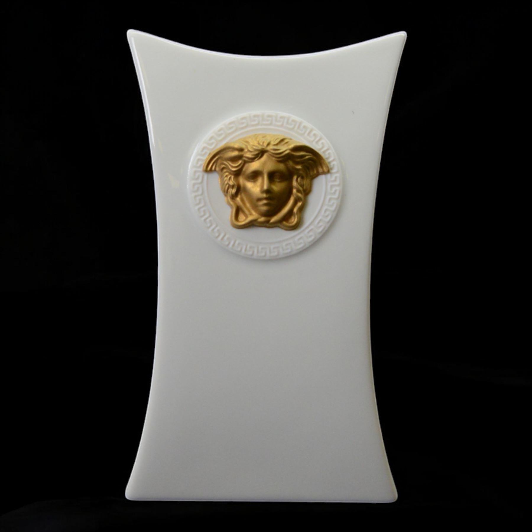 Rosenthal Versace Gorgona vase, of concave form, decorated in relief with medusa masks and gilt greek key borders upon a white ground, boxed, H17cm
