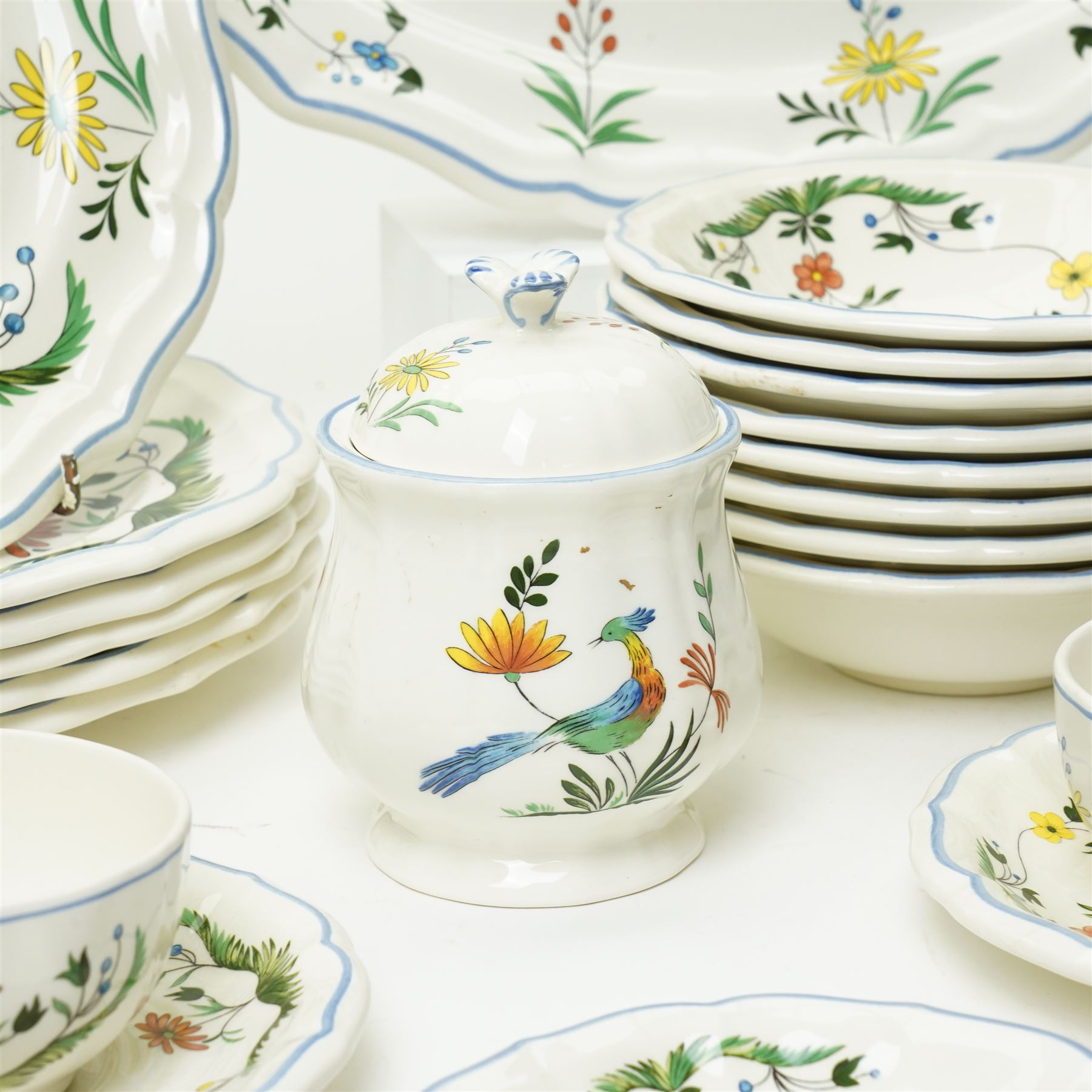 Gien France faience tea and dinner service in the 'Oiseaux de Paradis' pattern comprising six dinner plates, eight dessert plates, eight soup bowls, four cups, six saucers, oval plate, milk jug and sugar bowl and cover