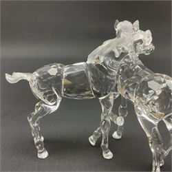 Five Swarovski Crystal horses, comprising stallion, rearing horse, pair of horses playing and Arabian stallion, each with frosted manes and tails, together with a small Swarovski Crystal galloping horse, the mane, tail and base with smoky tint