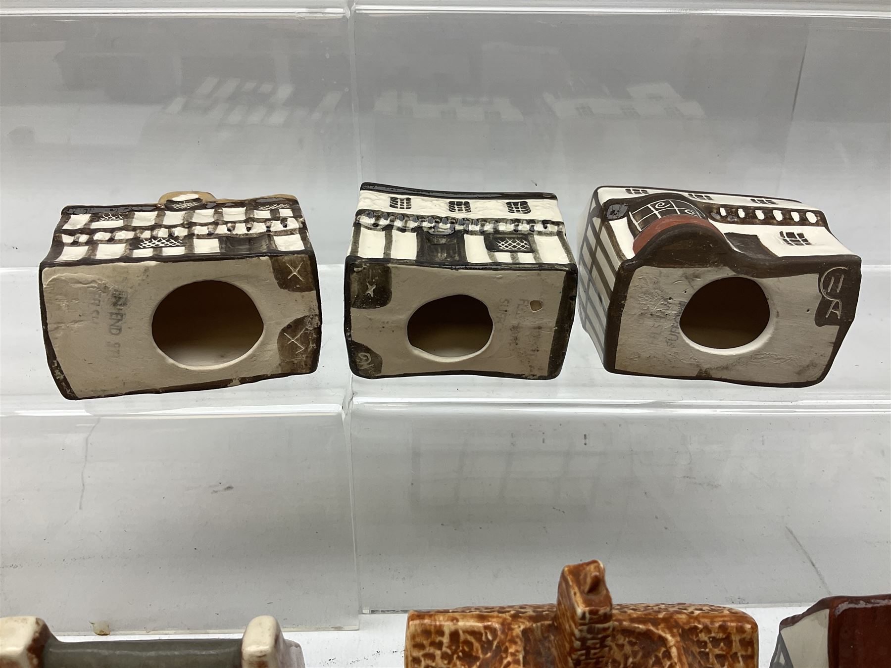 Twenty studio pottery figures of houses and cottages, comprising seventeen Mudlen End Studio Felsham Suffolk examples and two John Putman's Heritage Houses examples