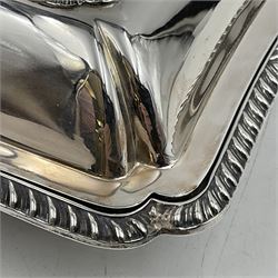 Early 20th century silver entree dish and cover, of rectangular form with shaped corners and oblique gadrooned borders to base and cover, the cover with loop 'bamboo' handle, hallmarked Thomas Bradbury & Sons Ltd, Sheffield 1930, including handle H10.5cm L24.5cm