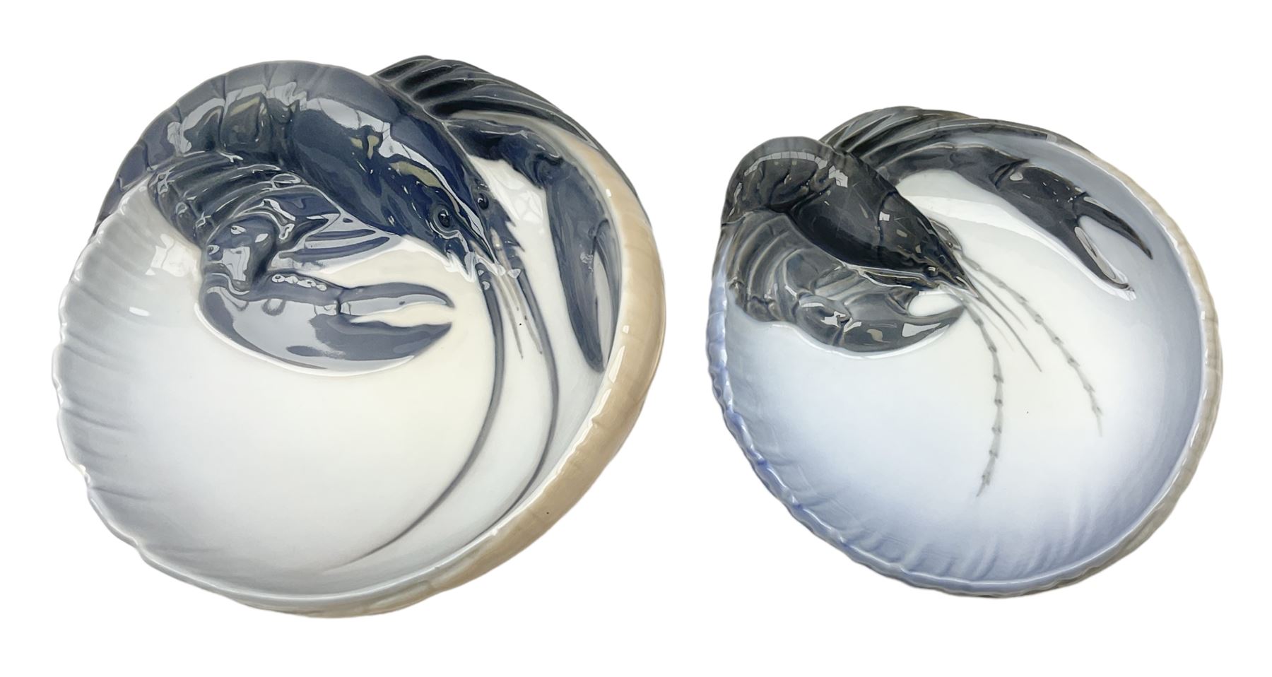 Pair of Royal Copenhagen bowls modelled as baskets and mounted with lobsters, model no 3498 and 3277, with painted and printed marks beneath, largest D19cm