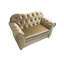 Chesterfield shaped snuggler sofa, upholstered in buttoned champagne fabric, with scatter cushions