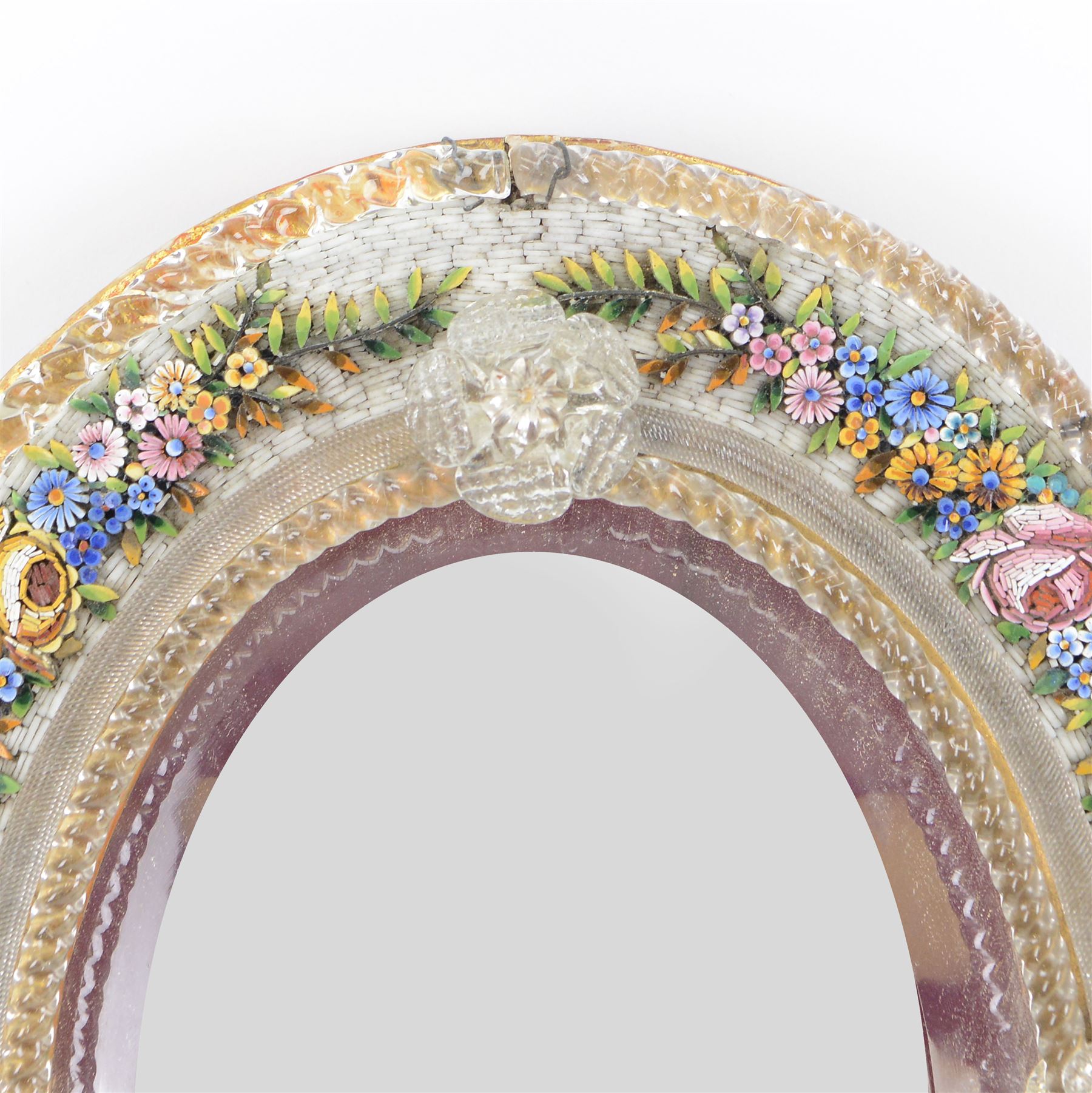 Late 19th/early 20th century Italian micro mosaic mirror decorated with flower heads amongst trailing leaves, applied with blown glass twisted borders, scrolls and flowerheads, upon a gilt wooden frame, H30cm