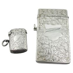 Edwardian silver card case, of curved oblong form, engraved with vacant cartouche surrounded by foliate scrolls, hallmarked Henry Matthews, Birmingham 1905, W8.5cm, together with an Edwardian silver vesta case, of rounded rectangular form, engraved with vacant circular panel surrounded by foliate scrolls, hallmarked William Neale, Chester 1901, approximate total weight 1.66 ozt (51.8 grams)