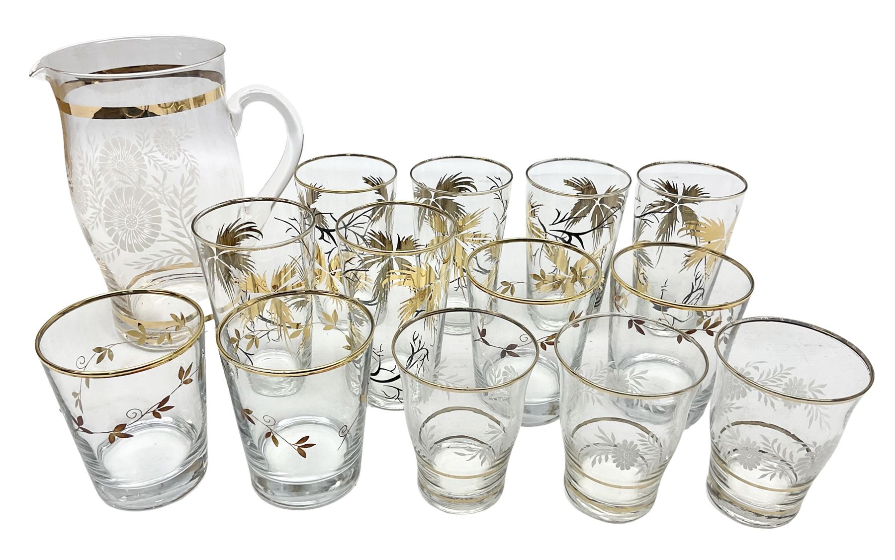 Mid 20th century glass part lemonade set comprisimg jug decorated with white floral sprays and gilt banding with three matching cups, together with a set of six tumblers decorated in black and gilt with flowers and set of four other glasses