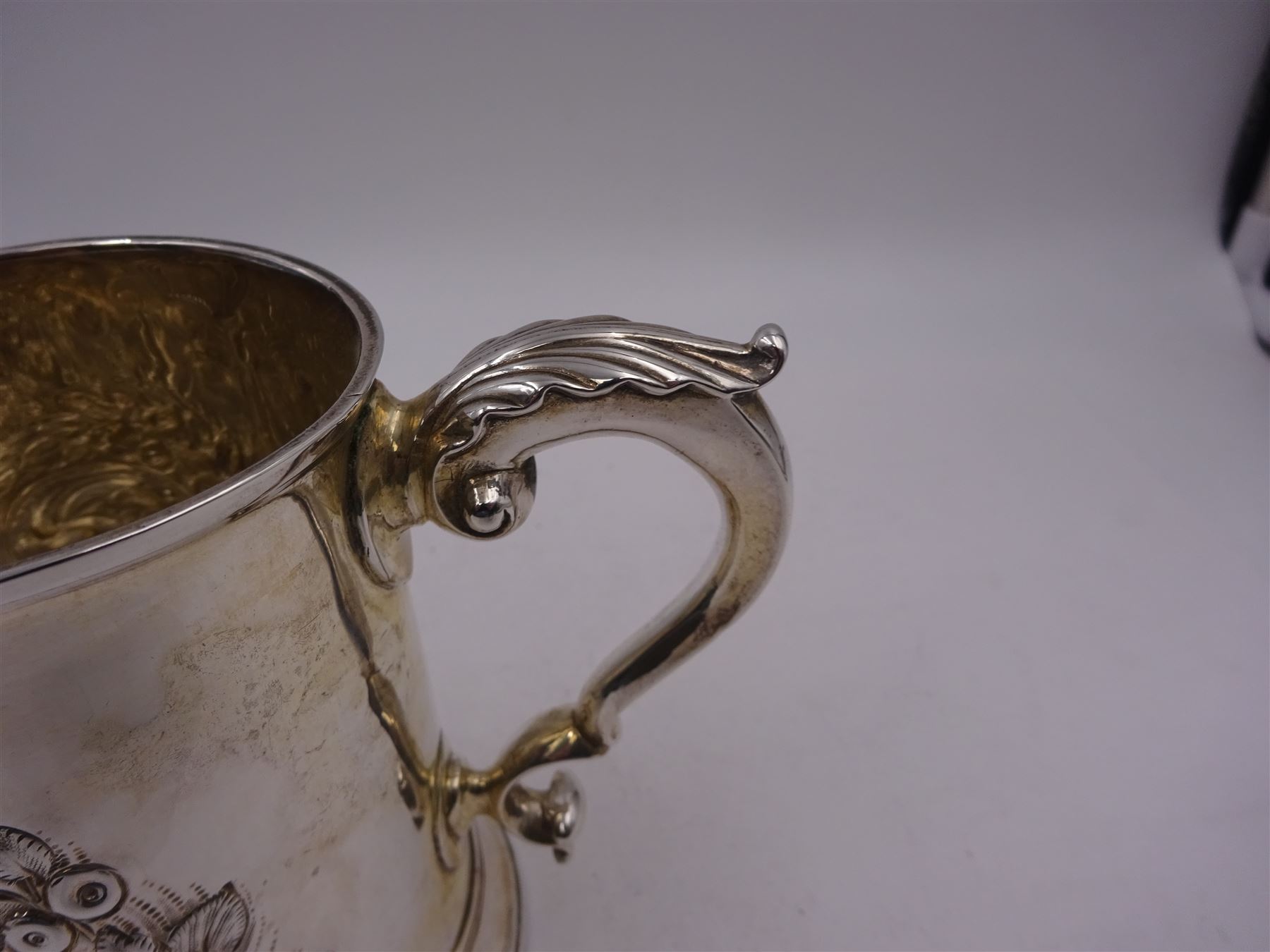 George III silver tankard, of slightly tapering cylindrical from, with chased and repousse crown above a monogrammed cartouche and floral, foliate and C scroll decoration, with acanthus capped C scroll handle, hallmarked WT, possibly William Turton, London 1774, H11.5cm