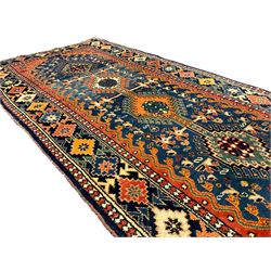 Persian blue ground rug, field decorated with four pole medallions with surrounding repeating bird motifs, coral spandrels with flowerheads, guarded border decorated with repeating geometric lozenges