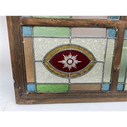 Leaded stained glass panel in frame, consisting of four panels in blue, green, peach, orange and red, W52cm H40cm