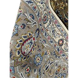 Persian Meshed carpet, ivory ground and decorated with intricate floral design with trailing scrolled branch, the central medallion decorated with stylised plant motifs, seven band border, the main band decorated with scrolls and flower head motifs