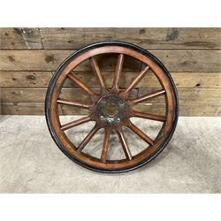 Set of four wheels from an early 20th century cart, wood with metal outer