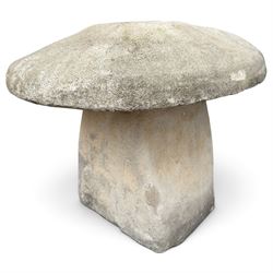 Weathered cast stone two-piece staddle stone of squat form, domed circular top over square-tapering pedestal base