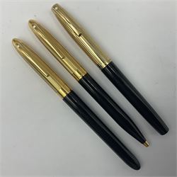 Sheaffer Crest fountain pen, the black barrel with gold plated cap and 18K nib, together with a matching ballpoint pen and further fountain pen, longest L14cm (3)