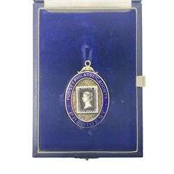 Silver and enamel oval locket pendant, inscribed Pudsey Philatelic Society President, and decorated in enamel with a Penny Black stamp, opening to reveal a gilt interior, with presentation engraving verso, hallmarked Haseler & Restall, Birmingham 1981, contained within fitted case, H6.5cm