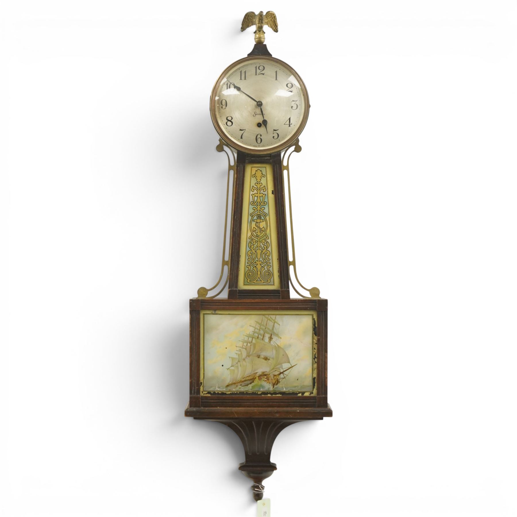  Early 20th century American wall clock by the Sessions Clock Company in banjo pattern case with eagle finial and shipping scene panel H108cm
