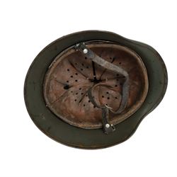 German Third Reich Waffen-SS M35 double decal helmet, the left inner brim stamped SF64, the back inner brim stamped 3866, with leather eight tongue liner and chinstrap