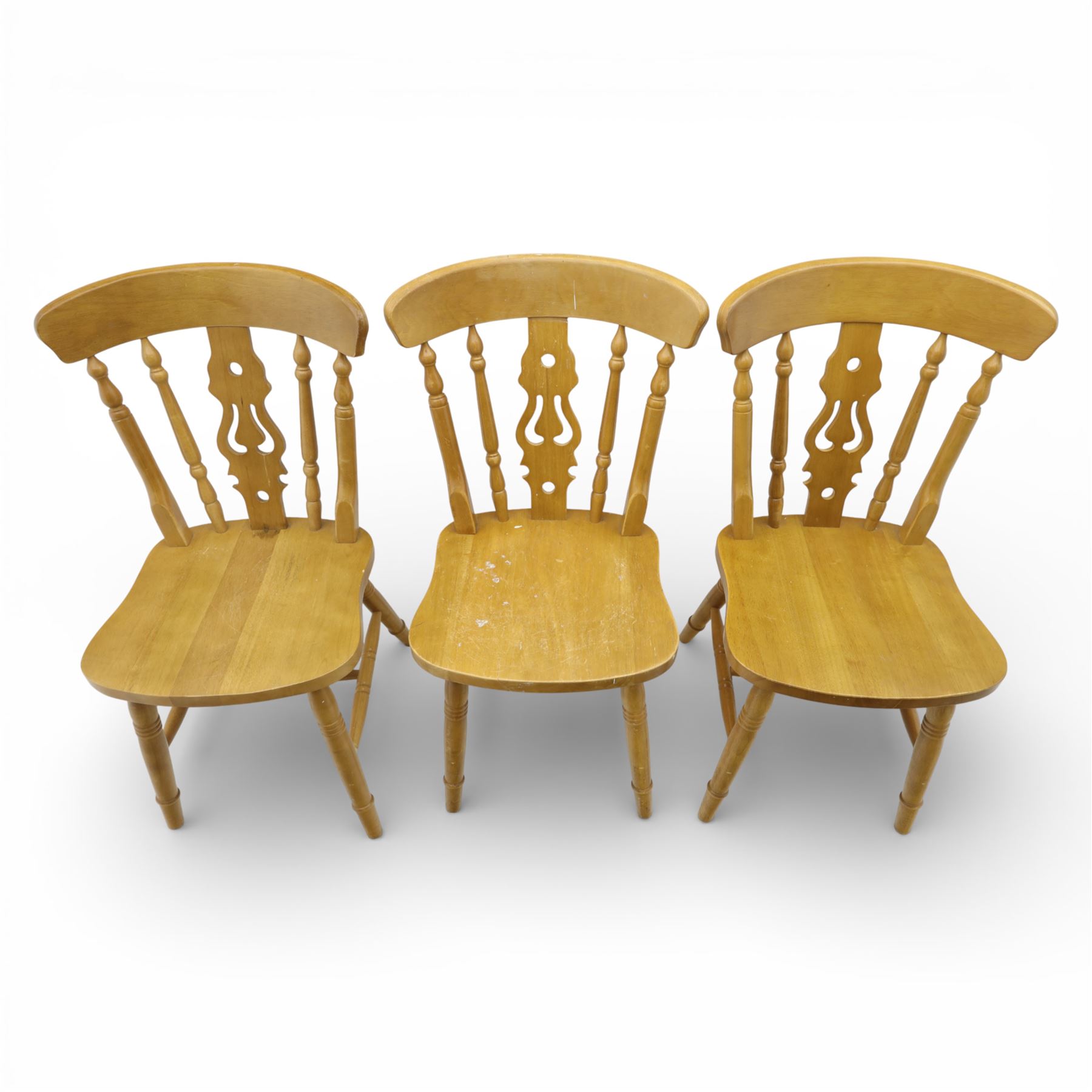 Solid oak dining table and set of seven pine farmhouse chairs including two carvers, rectangular top with tongue and groove style finish, supported a 'H' stretcher with square chamfered legs, pine farmhouse chairs with central splat and turned legs