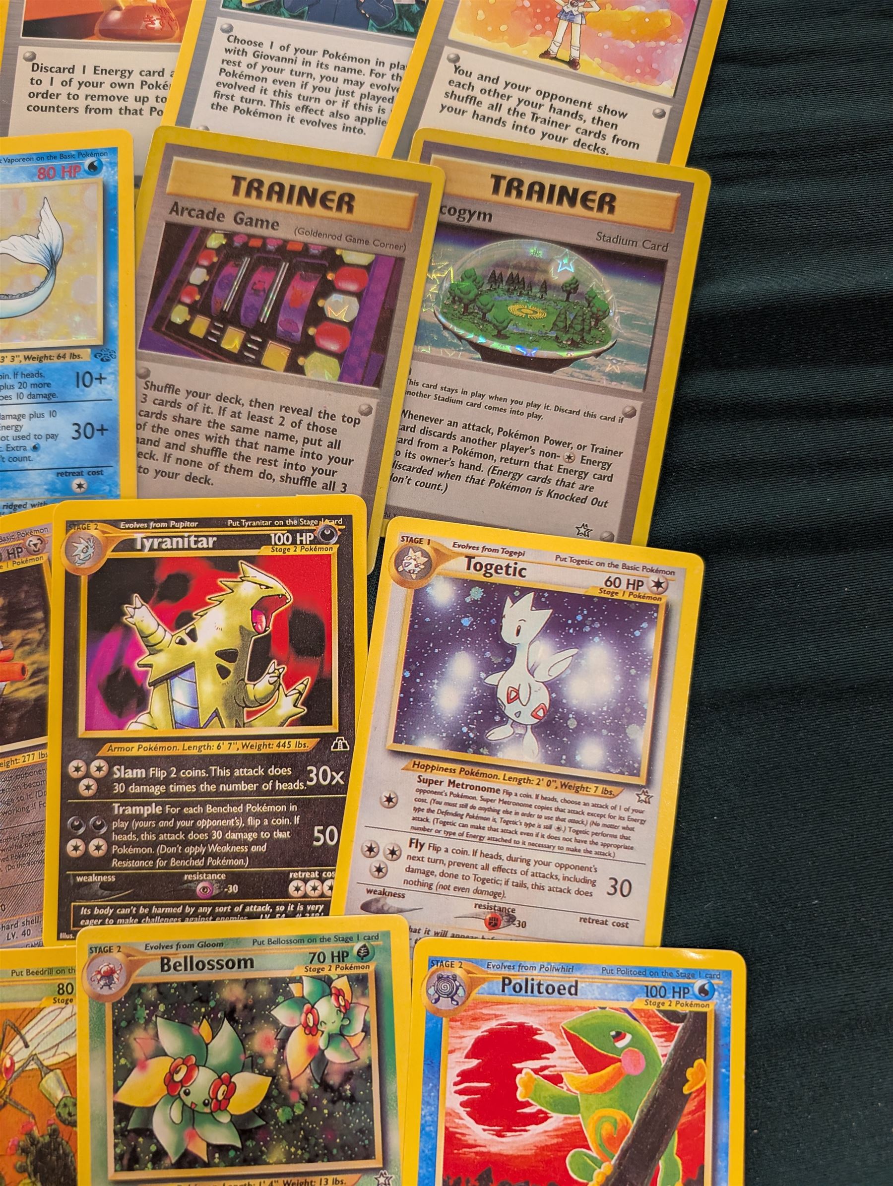 Collection of Pokemon TGC trading cards, including two WB First Movie Black Star promo cards Pikachu no. 4 and Dragonite no. 5, two Ancient Mew Black Star holo promo cards, Gym Challenge Giovanni's Persian 8/132 holo and a small collection WOTC, Neo Discovery and Neo Genesis cards, together with thirty four Bandai Carddass Pokemon cards, including prism Charizard no. 186 and Pokemon Topps cards including holo examples 