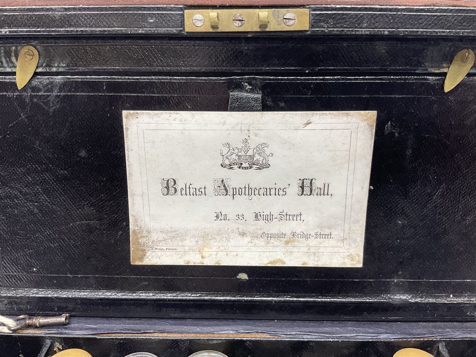 19th century apothecary leather carrying case, with key, the hinged lid opening to reveal seventeen glass medicine bottles with stoppers, most with chemist labels, gram scales, and domestic medicines booklet, H9cm, L27cm