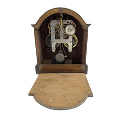 American - 8-day mahogany cased mantle clock by the Gilbert Clock Company c1910, break arch top, canted corners with inlay to the front on a raised plinth, cream card dial with Arabic numerals, minute track and steel spade hands,  twin open-spring driven movement striking the half-hours on a bell and the hours on a coiled gong. With pendulum.