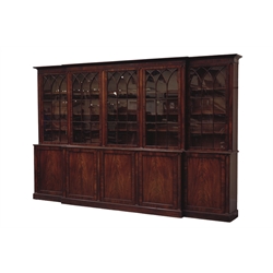  Large Georgian mahogany break-front library bookcase, projecting moulded cornice and figured frieze above five Gothic arch astragal glazed doors and pilasters, enclosing fifteen adjustable shelves, the projecting base with five figured panelled cupboard doors below, plinth base, W376cm, H240cm, D51cm Provenance - Wydale Hall, Brompton-By-Sawdon North Yorkshire, former home of the Cayley family, sold by David Duggleby 01/07/06: South Wood Hall, Cottingham, Hull,    