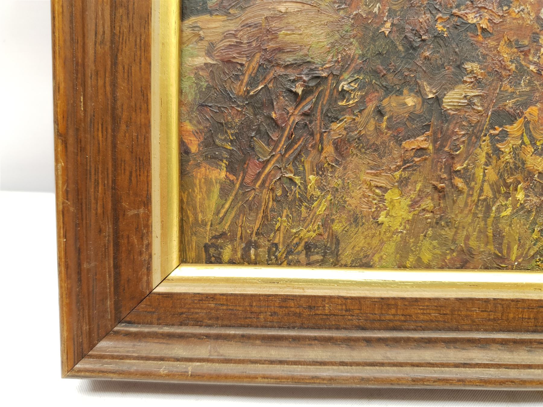 Reginald Green (British 1884-1971): Cattle Grazing on a Wooded Hillside, oil on board signed 22cm x 32cm