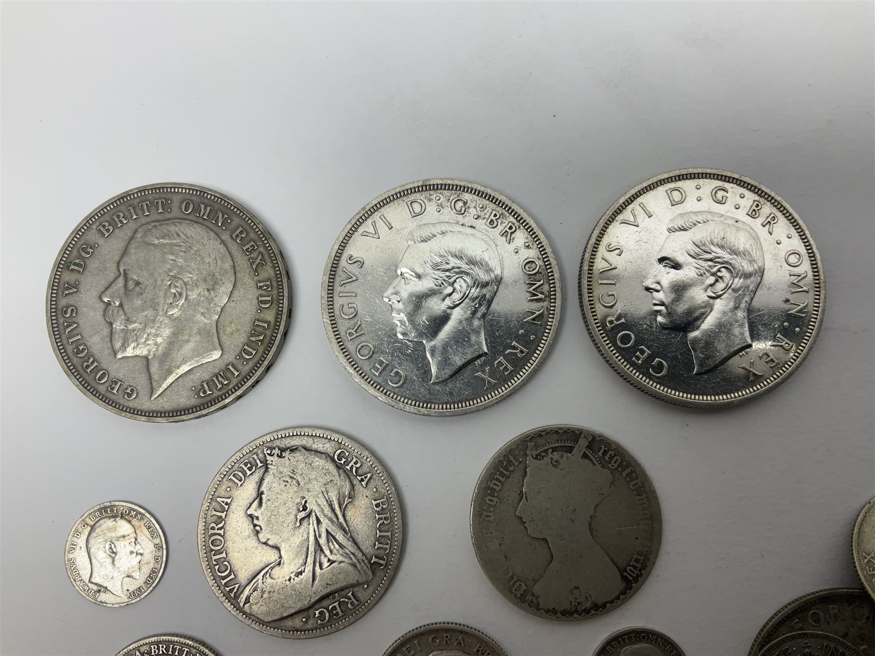 Approximately 65 grams of Great British pre 1920 silver coins and approximately 230 grams of pre 1947 silver coins, including King George V 1935 crown and two King George VI 1937 crowns