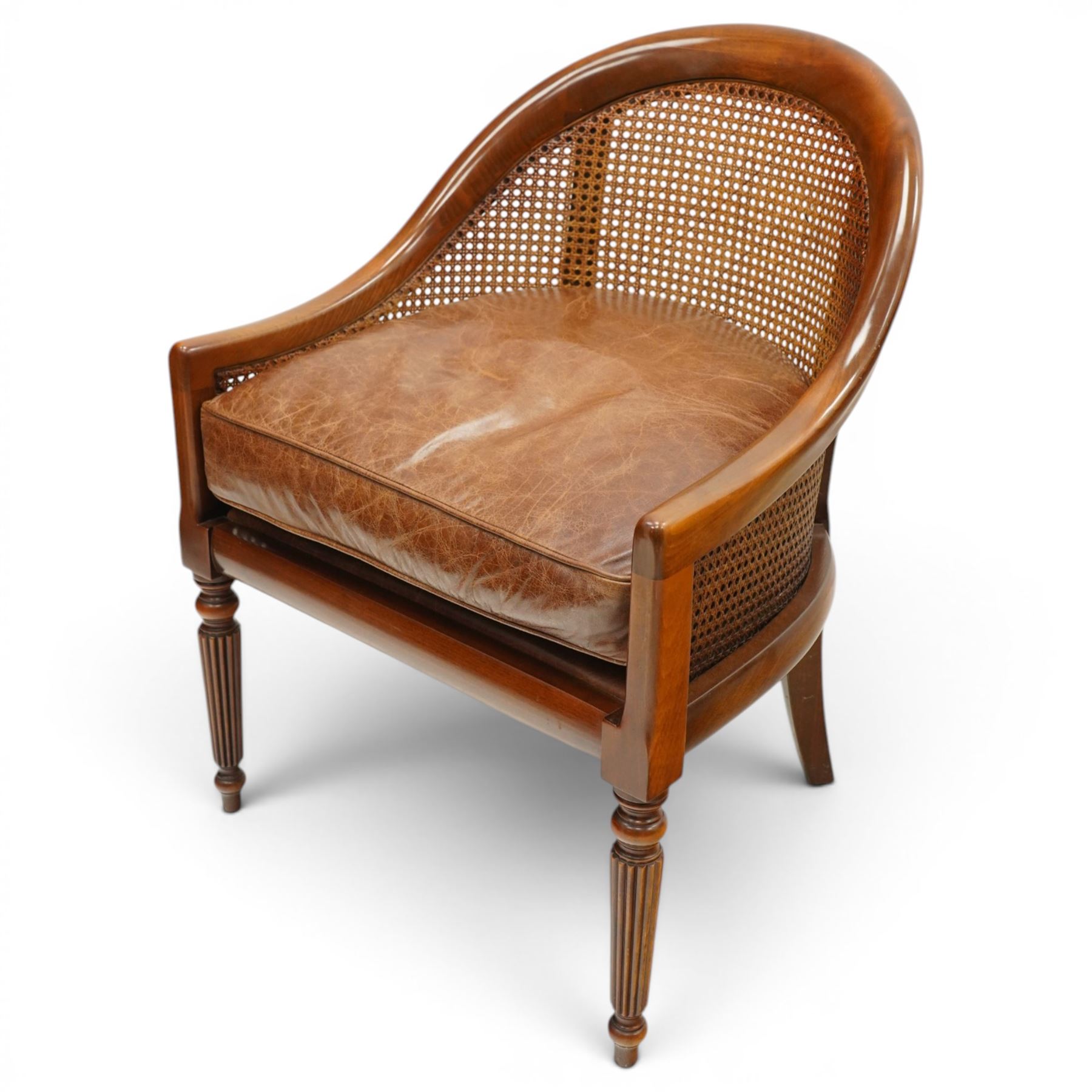 Laura Ashley - pair of bergère tub armchairs with leather seats, raised on fluted and turned supports
