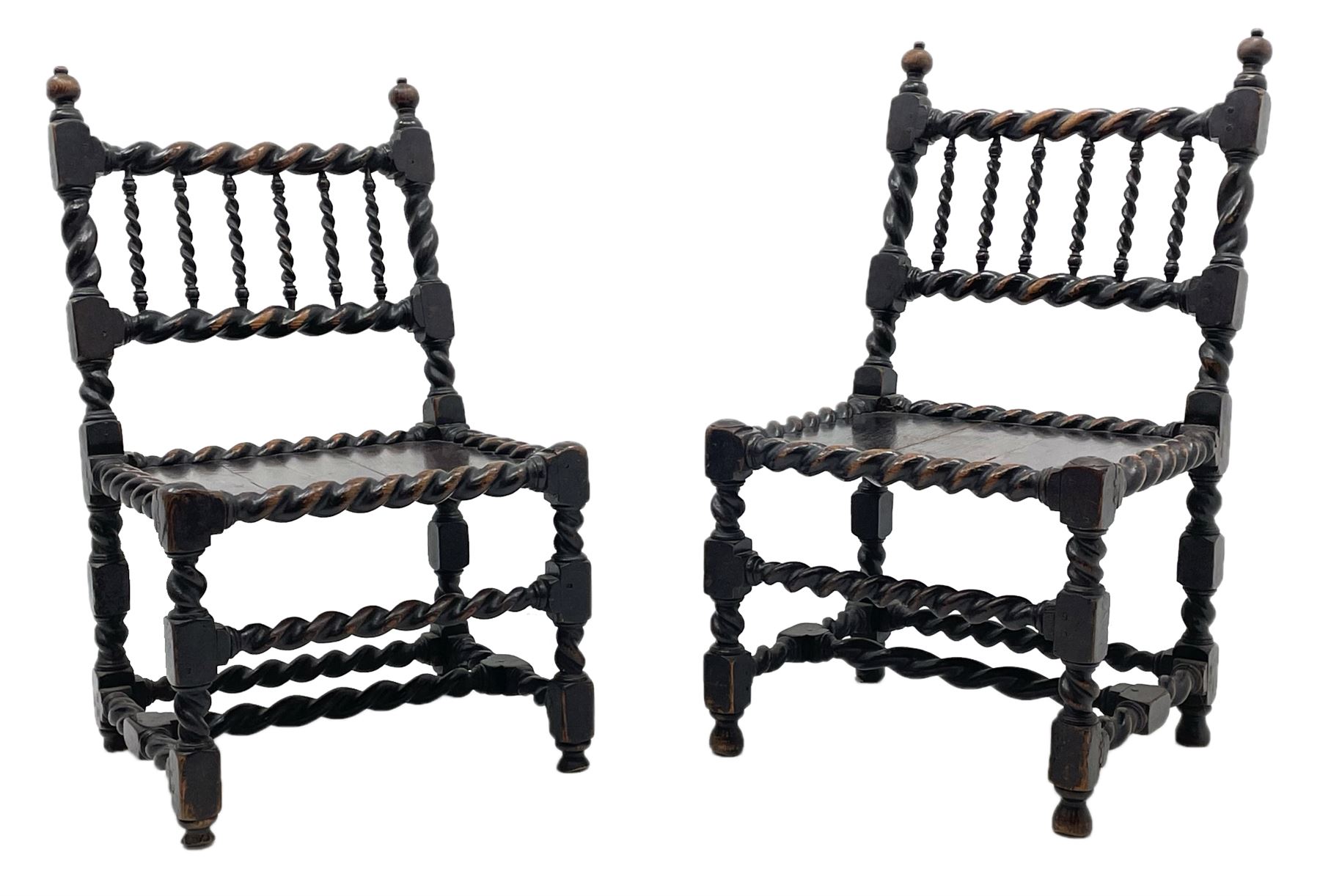 Unusual pair late 17th century oak spindle-back chairs, barley twist or spiral turned throughout, the back with a row of six vertical turned spindles, the supports joined by two lower rails and front central rail, plank seats

Provenance - The chairs illustrated in 'Early British Chairs and Seats 1500-1700' by Tobias Jellinek (Pub: Antique Collectors Club. 2009. p 313). Previous part of a private collection. Vendor purchased from auction 2014.

Measurements - seat width - 48cm, seat height - 38cm/36cm, depth - 50cm, total height - 85cm/82cm