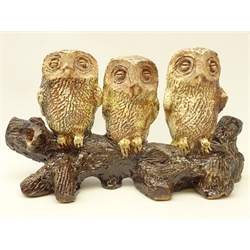  Peter Hough (British Contemporary) group of three  barn owls perched on branch with carved decoration and brown glaze, L35cm   