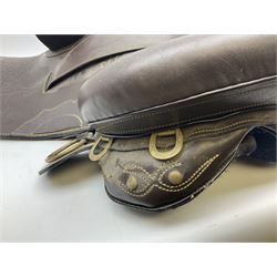 Brown leather western saddle with decorative design and stiching with stirrups and girth, saddle L48cm
