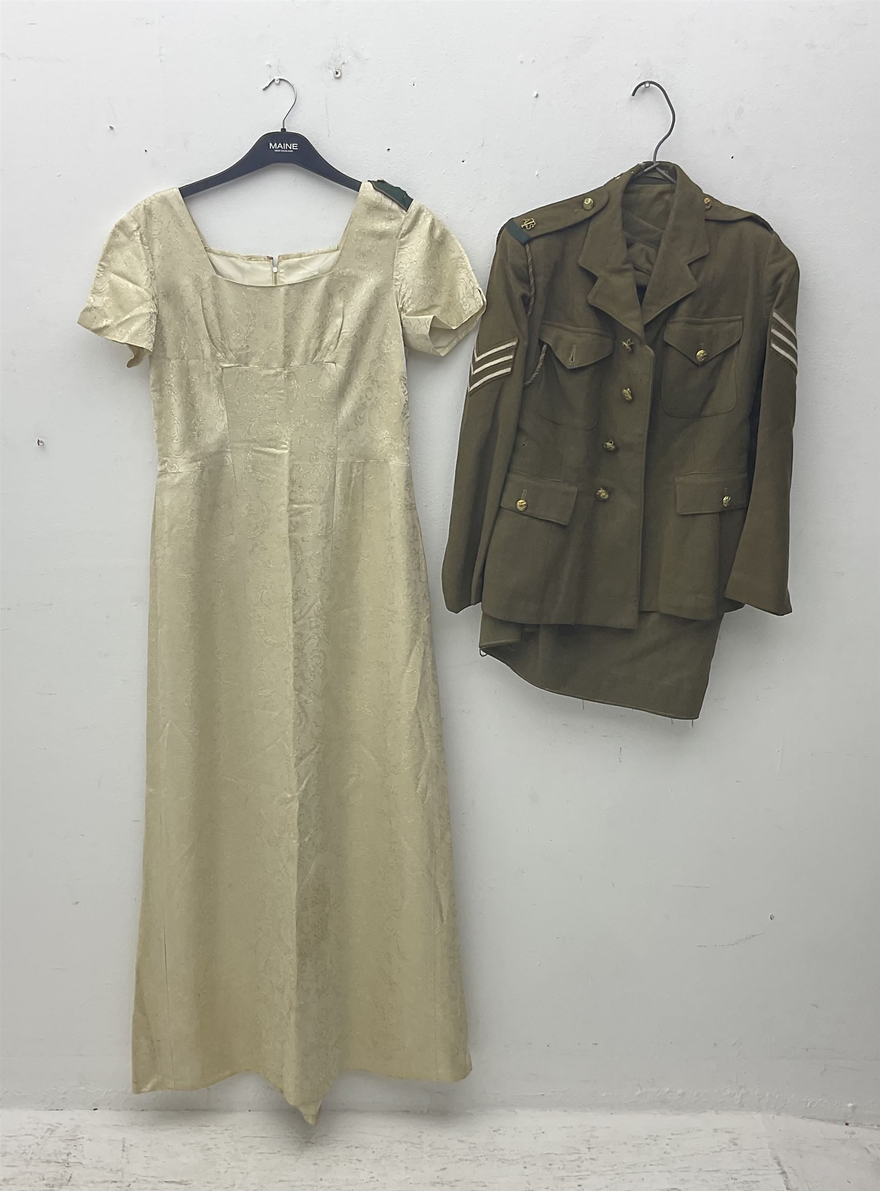 WW2 British female ATS Sergeant's service uniform grouping, consisting of four pocket female pattern service dress tunic with brass ATS shoulder titles and general service buttons; cloth lined interior with the original printed size label dated 1942; the matching khaki service dress skirt; and Greatcoat with size label dated 1945; together with army knitted sleeveless V-neck jumper; WRAC tunic, skirt and overcoat; full length cream and gold thread military evening dress by Hilliers Couture; and four webbing belts