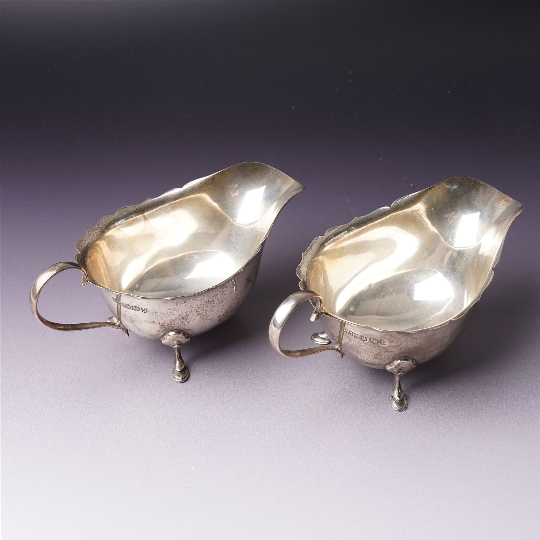 Pair of silver sauce boats with crimped rims Sheffield 1935 Maker Mappin & Webb, small embossed silver tray and two other small trays