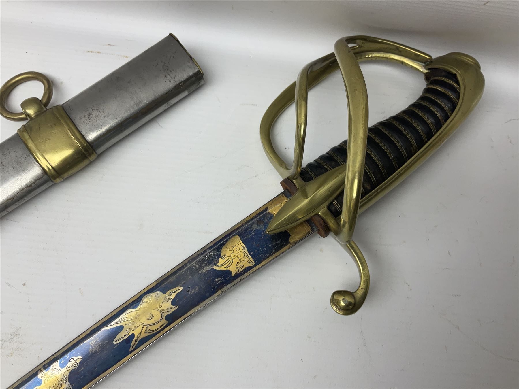 Early 19th century French Lancers officer's sword c1810, the 84cm curving fullered blade retaining most of its bluing, gilding and engraved decoration, inscribed I.S.& C. to ricasso (for Schimelbusch), brass three-bar hilt with elongated elliptical langets and wire-bound leather grip; in polished steel scabbard with two brass suspension rings L100cm overall