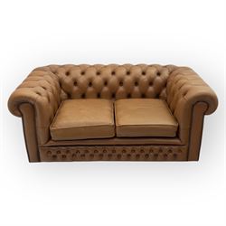 Contemporary tan leather chesterfield settee, deep button upholstered throughout with rolled arms and back of equal height, brass stud detailing, twin seat cushions