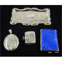 Silver blue guilloche enamel match case holder by William Neale, Birmingham 1932, silver vesta with applied thistle decoration by Henry Williamson Ltd, Birmingham 1906, silver hinged locket and a silver pin tray hallmarked 
