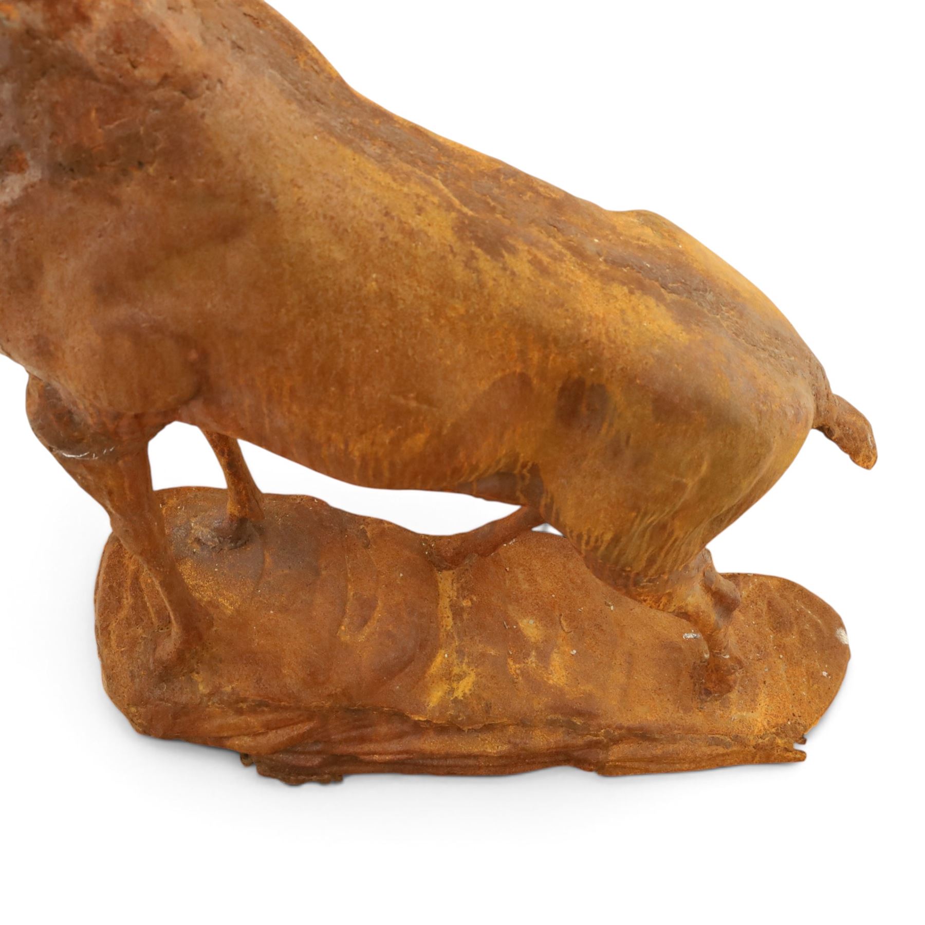Pair of cast iron stags, upon a on moulded rocky plinth, standing alert 