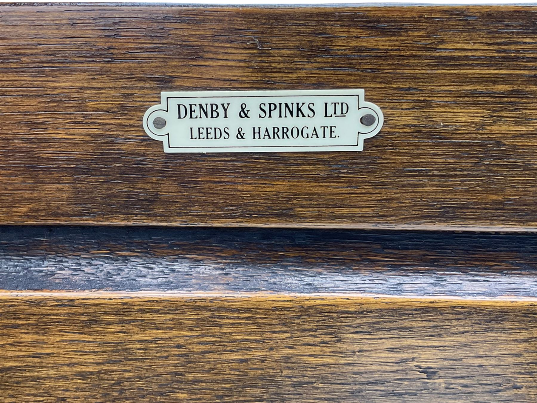 20th century carved oak court cupboard, s-scroll carved frieze over panelled cupboard door carved with arch, lobe and scroll carved cup and cover supports, fitted with three drawers and three cupboards below