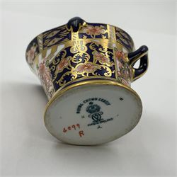 Group of Crown Derby and Royal Crown Derby Imari pattern miniatures, including mid 19th century Stevenson and Hancock cauldron, with painted mark beneath, H5.5cm, a near pair of early Royal Crown Derby scuttles, decorated in the 6299 pattern, each with printed and painted marks beneath including illustration date codes for 1913 and 1922, tallest 6.5cm, and a further early 20th century Royal Crown Derby scuttle, decorated in the 6299 pattern, with printed and painted marks beneath including illustration date code for 1922, H5.5cm, (4)
