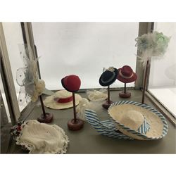 Early 20th century scratch-built wooden hat & gown shop diorama 'Joan', of double-fronted form glazed on three sides with brass and aluminium mounts, rear access apertures and storage under L63cm H45cm D31cm; with small collection of dresses and hats on display stands