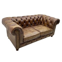 HALO - Chesterfield style two seat sofa upholstered in buttoned brown leather with stud work, on turned feet with castors