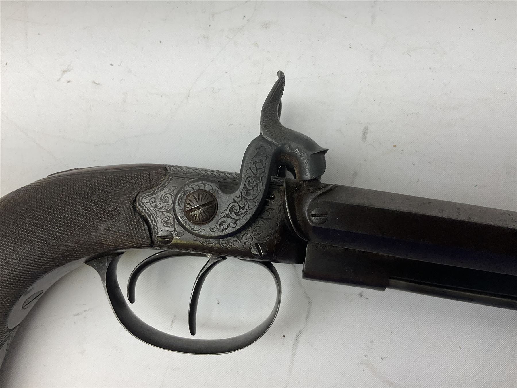 Early 19c percussion double barrel Howdah pistol by J. Blisset London, c1840s, approximately 50 calibre, 10.5cm octagonal monobloc barrels with captive swivel ramrod under, finely chequered walnut stock, engraved hammers, lock plates, tang and trigger guard, butt plate with hinged cap compartment, vacant white metal oval escutcheon L25.5cm overall