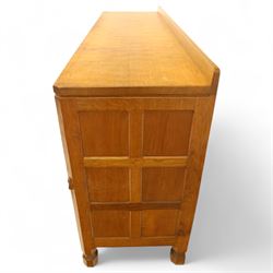 Mouseman - oak sideboard with adzed top and raised gallery back, over two short drawers and three long drawers, flanked by panelled cupboard doors with wrought iron fittings, on octagonal feet, carved with the signature mouse to the right-hand door