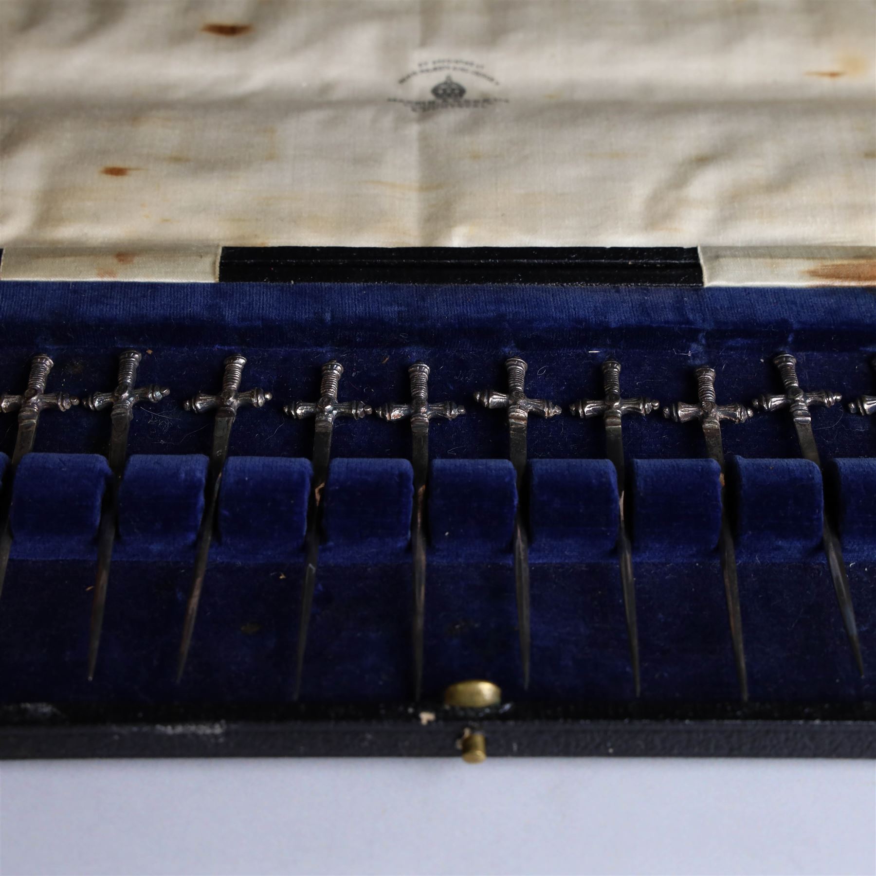 Set of twelve 1920s silver novelty cocktail sticks, modelled as swords, hallmarked Mappin and Webb, Sheffield 1929, contained within tooled leather case