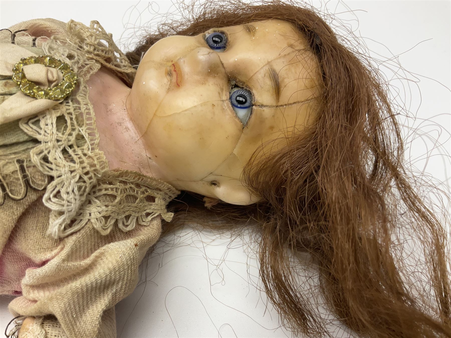 Victorian wax shoulder head doll with applied hair, inset glass eyes and jointed body with composition lower limbs; faded pink dress H35cm